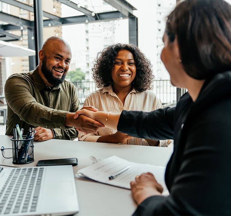 a group of people looking at a laptop